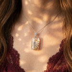 Model wearing the rectangular Enchanted Forest Garden Quartz Pendant in white gold vermeil. Display chain not included.