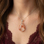 Starlight Petal Garden Quartz pendant on model, delicate petal inclusions
