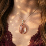 Scarlet Canopy Garden Quartz pendant on model, bold crimson forest inclusions