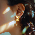 Rose stud earrings on model, 18K yellow gold vermeil
